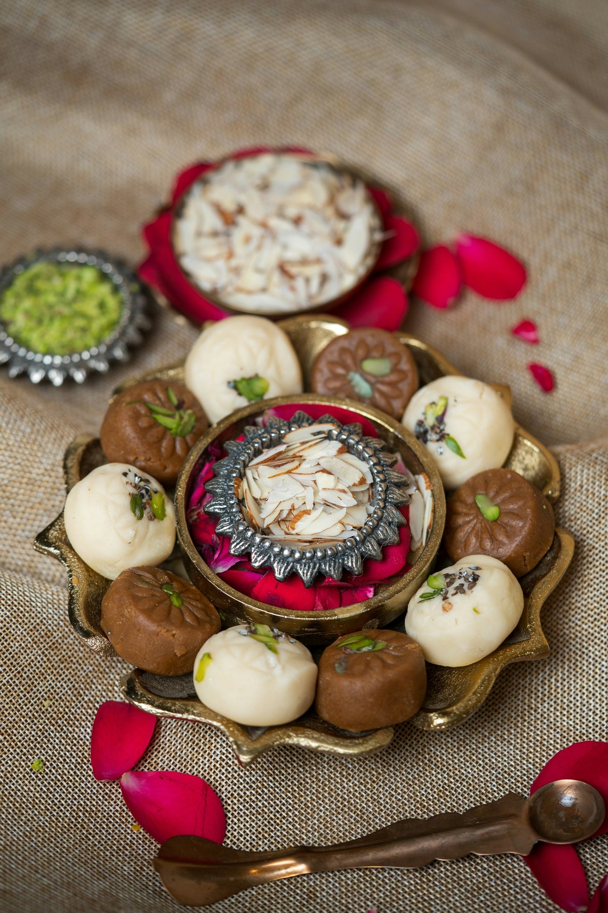 A festive platter of sweets and sliced almonds with rose petals